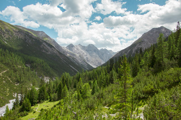 Fototapeta na wymiar Valley view in Swiss Alps during a hiking day in Summer in Engadin, Switzerland
