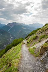Mountain trail in Swiss Alps during a hiking day in Summer in Engadin, Switzerland
