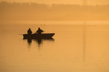 Orange sunrise on the lake. Golden autumn morning