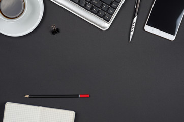 Business objects on a black desk.