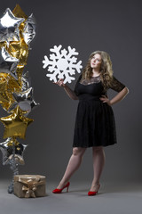 Plus size woman with gift box, snowflake and balloons