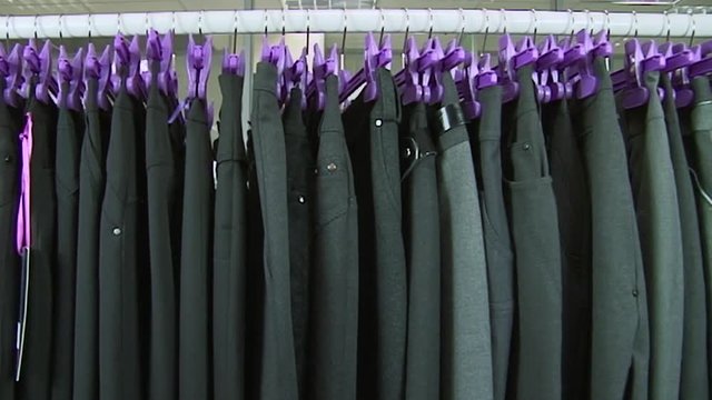 Old-fashioned ugly horrible women clothing on rack in collective farm Uryupinsk. Anti-advertising. How not to do.