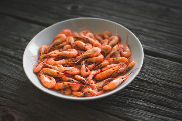 on a white plate on wooden background shrimp