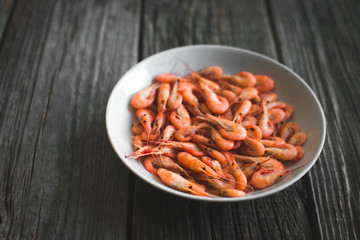 on a white plate on wooden background shrimp