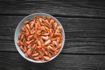on a white plate on wooden background shrimp