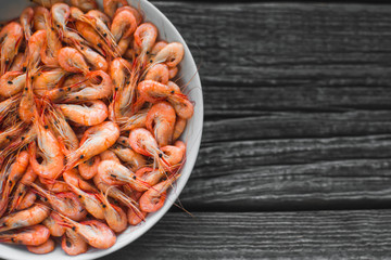 on a white plate on wooden background shrimp