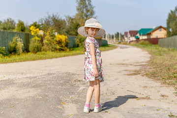 6-year-old girl standing on rural road