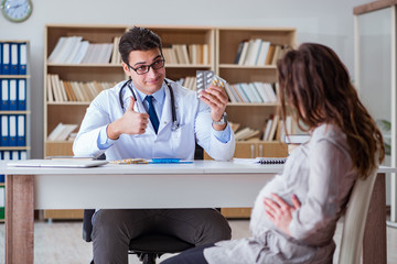 Fototapeta premium Pregnant woman visiting doctor for consultation