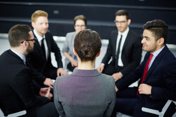 Group of managers listening to financial or economical expert report during business training