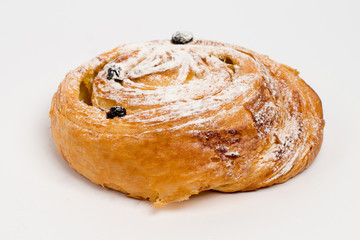 Sweet cinnamon bun roll swirl isolated over the white background