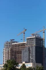 Fototapeta na wymiar High-rise construction. Construction cranes. Crane arm.