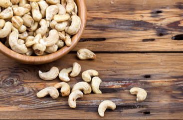 Raw cashews close-up in wooden bowl
