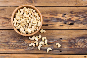 Raw cashews close-up in wooden bowl