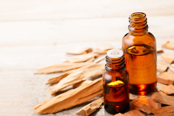 Sandalwood essential oil and wood block on the table