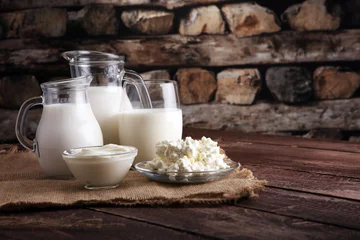 Peel and stick wall murals Dairy products milk products. tasty healthy dairy products on a table on. sour cream in a bowl, cottage cheese bowl, cream in a a bank and milk jar, glass bottle and in a glass