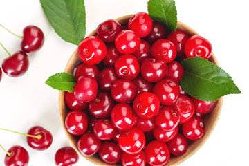 ripe juicy cherry berries with leaves in a plate