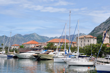 Fototapeta na wymiar City embankment with sailboats in the city of Kotor, Montenegro