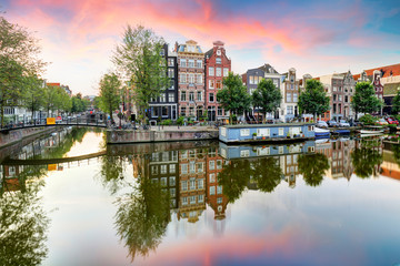 Fototapeta na wymiar Amsterdam Canal houses at sunset reflections, Netherlands