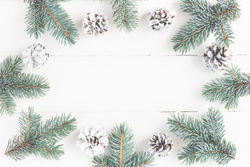 Christmas composition. Frame made of fir branches on white wooden background. Christmas, winter concept. Flat lay, top view, copy space