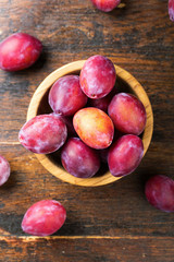 ripe plums on a wooden background