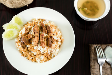 Rice, pork and chicken with fish sauce soup on the dining table.