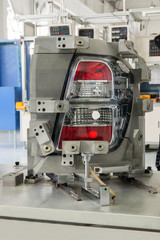close-up factory equipment of quality control of car headlight. testing for compliance with the standard 