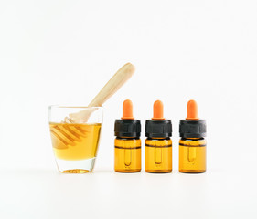 Ingredients of skin care products. And honey in the glass, Blank label package for mockup on white background and flowers. The concept of natural beauty products.