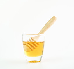Honey in a glass put on white background
