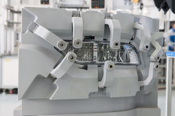 close-up factory equipment of quality control of car headlight. testing for compliance with the...