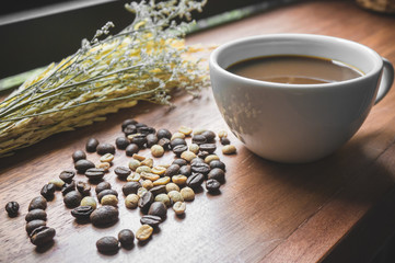 Coffee bean texture closeup with coffee cup for advertisement