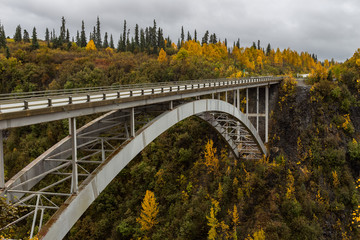 Fall colors surround the bridge over Hurricane Gulch in Alaska.