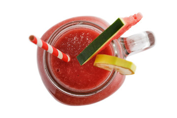 Freshly made smoothies from slices of watermelon and banana in a glass jar on a white background, top view