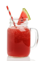 Freshly made smoothies of watermelon in a glass jar on a white background