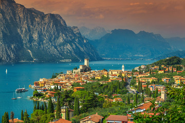 Amazing Malcesine tourist resort and high mountains, Garda lake, Italy - obrazy, fototapety, plakaty