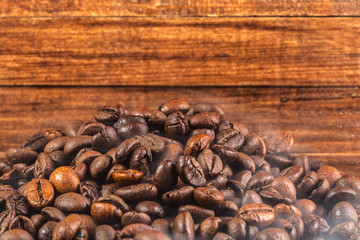 Coffee beans on wood background