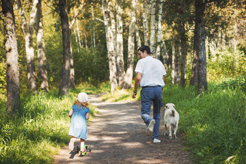 Naklejka na ściany i meble happy family with pet dog at picnic in a Sunny summer day. pregn