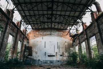 Fototapeta na wymiar Destroyed by war abandoned industrial wharehouse