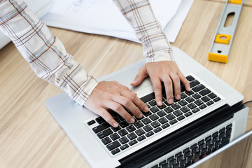 Concept of engineering working on workplace using laptop computer.