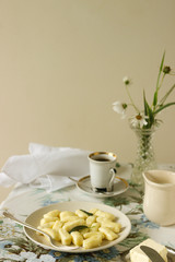 Homemade cottage cheese gnocchi or vareniki with sage oil. Useful breakfast. Gnocchi, coffee, milk. Rustic style, selective focus.