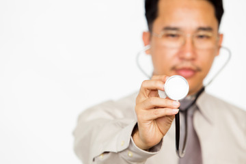 Asian doctor showing a stethoscope in the front close up on solid white background.