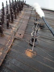 close up on details of an old traditional wood dulcimer