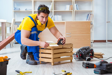 Repairman carpenter working with wooden board plank and measurin
