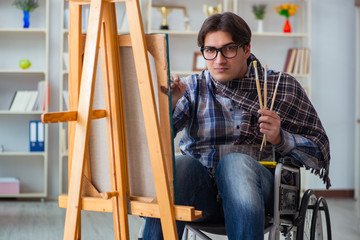 Fototapeta na wymiar Disabled artist painting picture in studio
