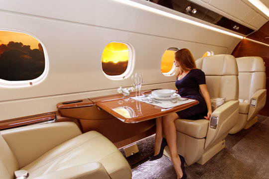 young beautiful woman in Luxury interior in the business jet
