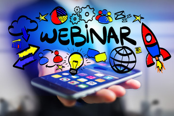 Concept of man holding interactive interface with webinar title and multimedia icons flying all around - Internet concept