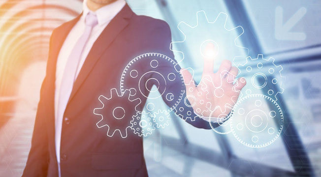 Businessman touching technology interface with gear wheel setting