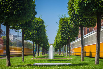 Budapest, Hungary - Fountains at the center of Budapest with iconic yellow trams on the move on a bright summer day