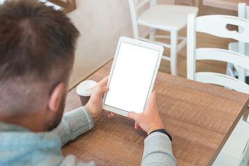 Tablet with isolated screen in man hand. Blank screen for mockup.