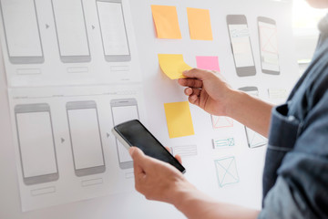 Web designer planning application for mobile phone.