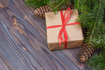 Naklejka na ściany i meble Christmas tree branch, decorations and gift box on white wooden table